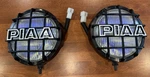 Vintage Pair Piaa Driving Lights - 5.5 Lens Covers, Harness. Fixed Price $179.99.